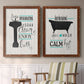 Set of two maple barnwood framed canvas prints depicting two graphic bathroom word art featuring playful bathtub silhouettes and bath-themed typography above a sideboard in a cozy sitting room.