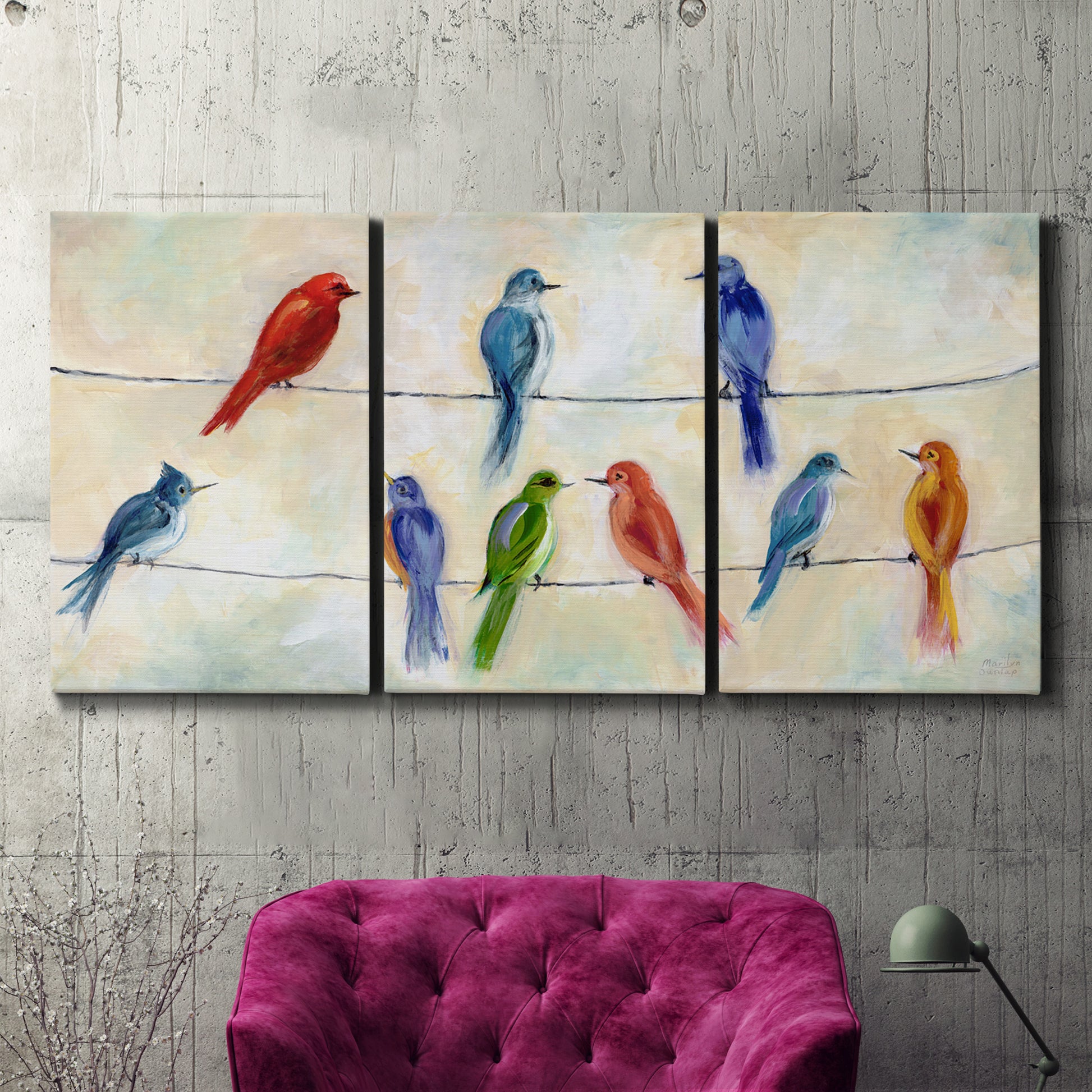 Three-panel canvas wall art featuring whimsical animal chatter illustration, displayed in a living room above a suede accent chair.