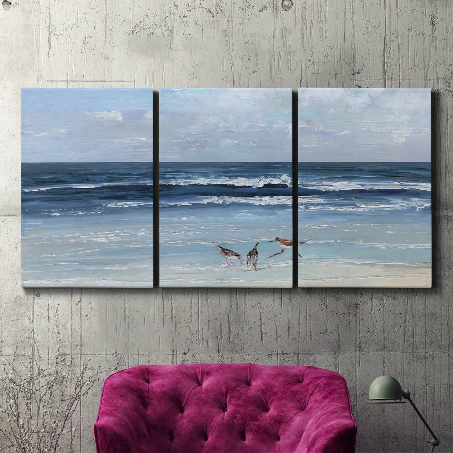Three-panel canvas wall art featuring loose farmhouse style floral painting, displayed in a living room above a suede accent chair.
