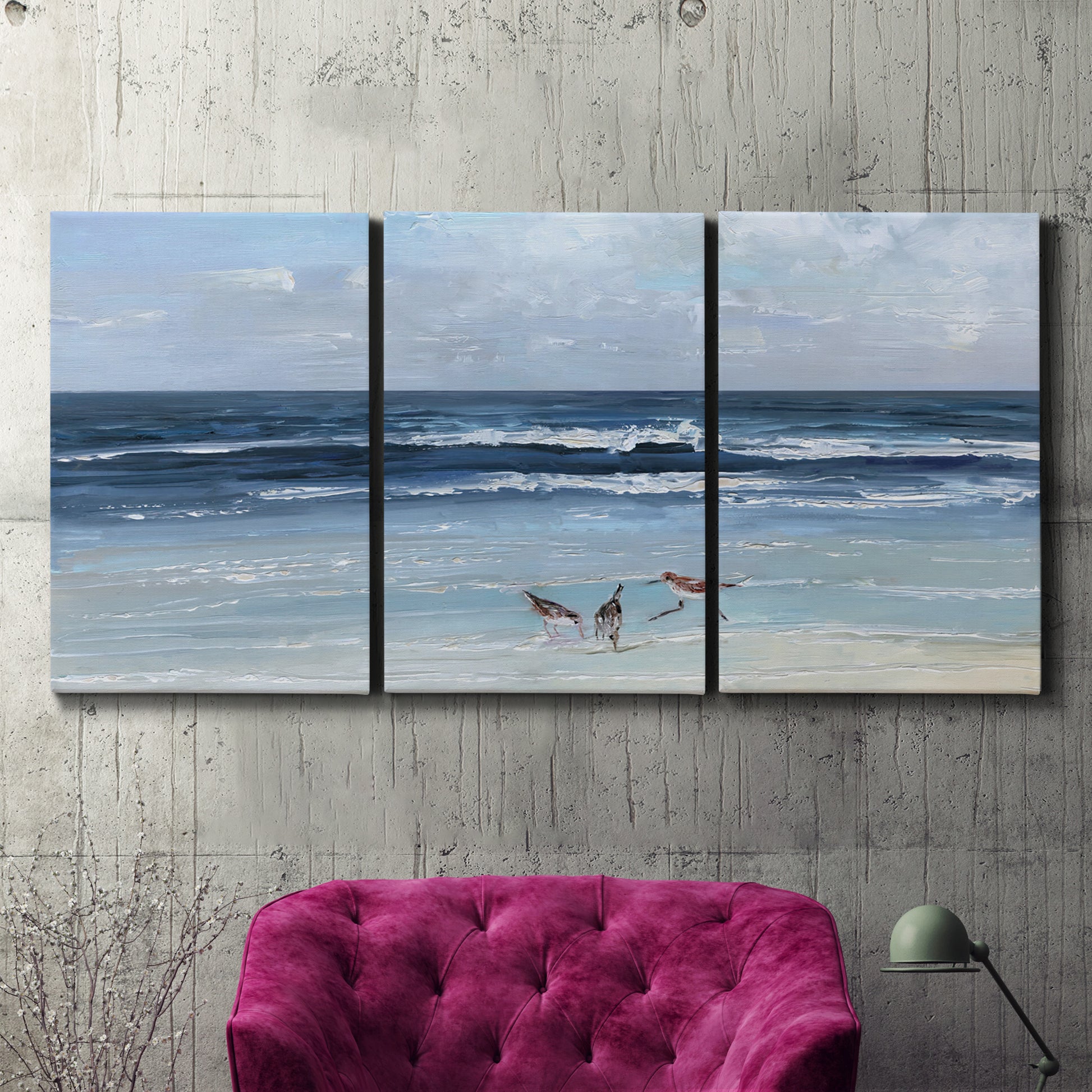 Three-panel canvas wall art featuring loose farmhouse style floral painting, displayed in a living room above a suede accent chair.