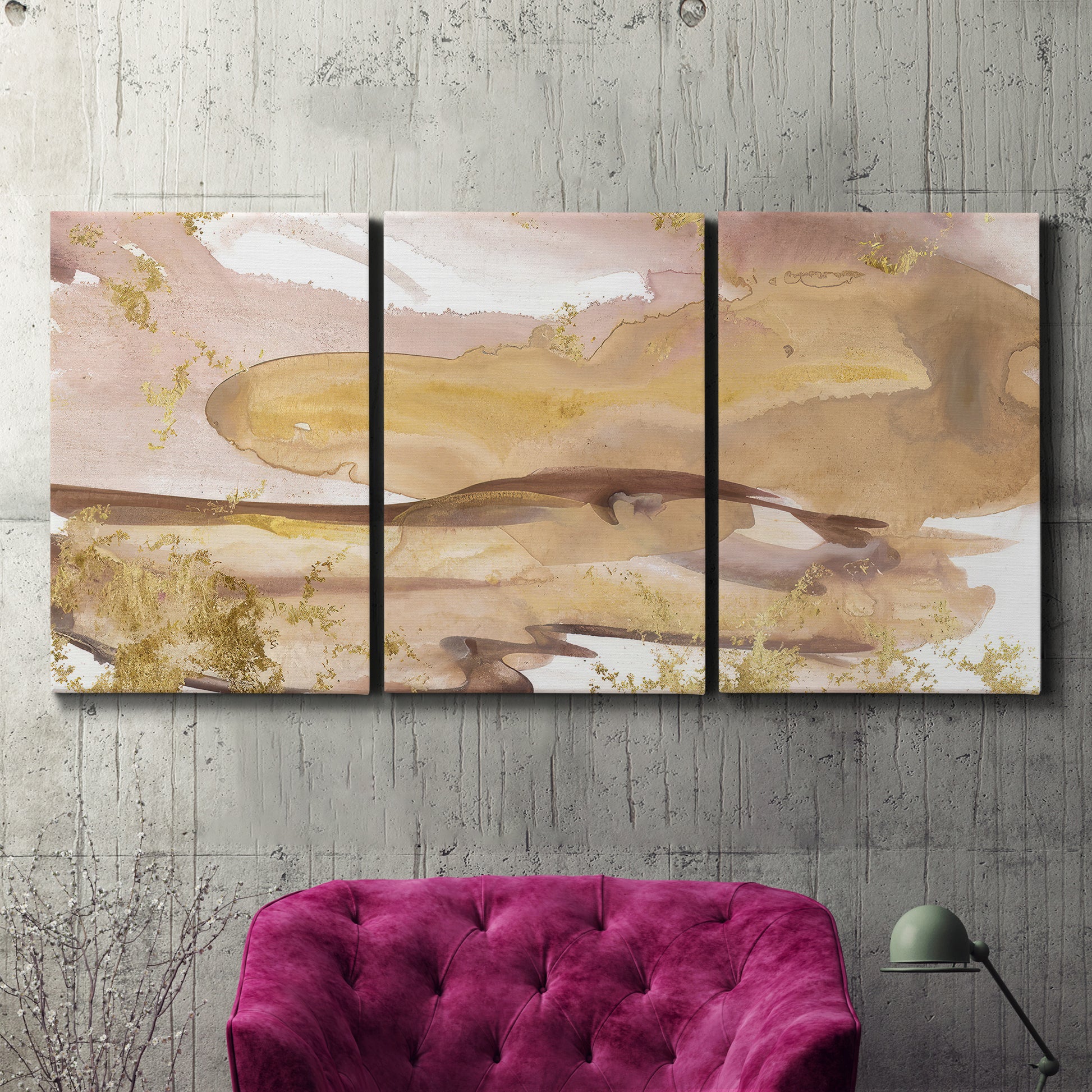 Three-panel canvas wall art featuring layered abstract dawn tones, displayed in a living room above a suede accent chair.