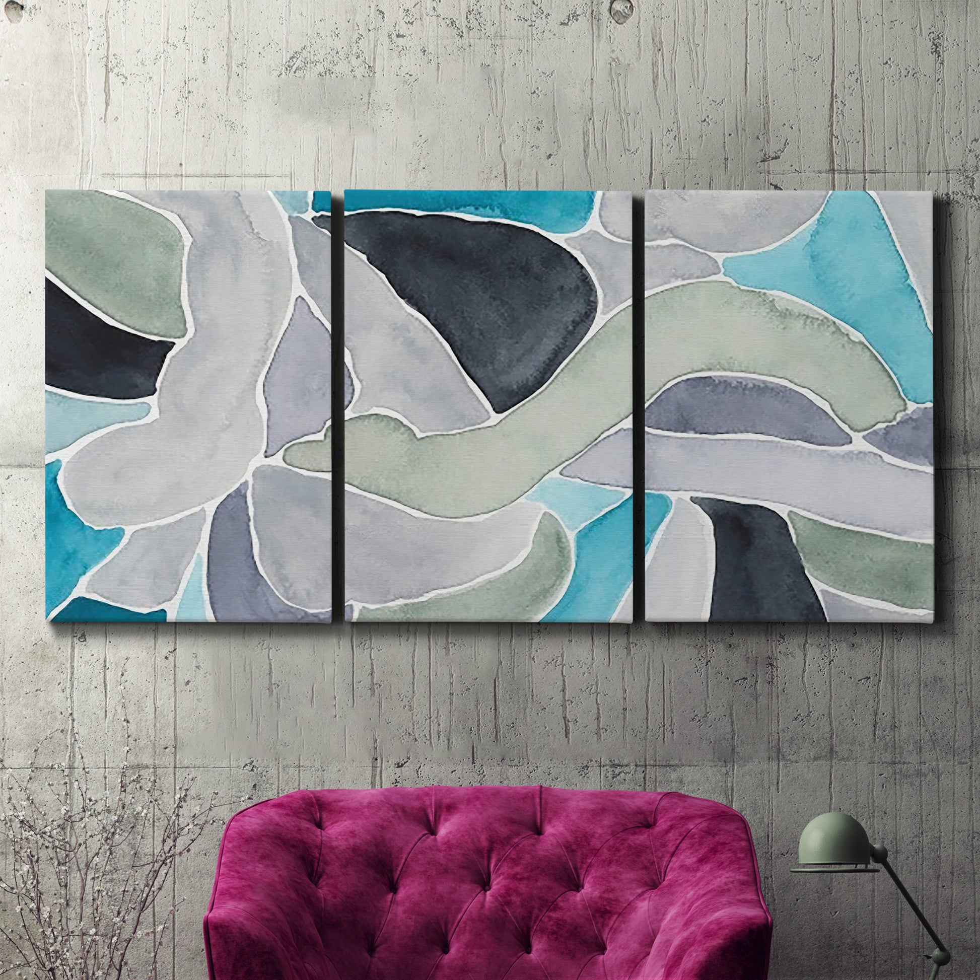 Three-panel canvas wall art featuring subtle abstract billowing color layers, displayed in a living room above a suede accent chair.