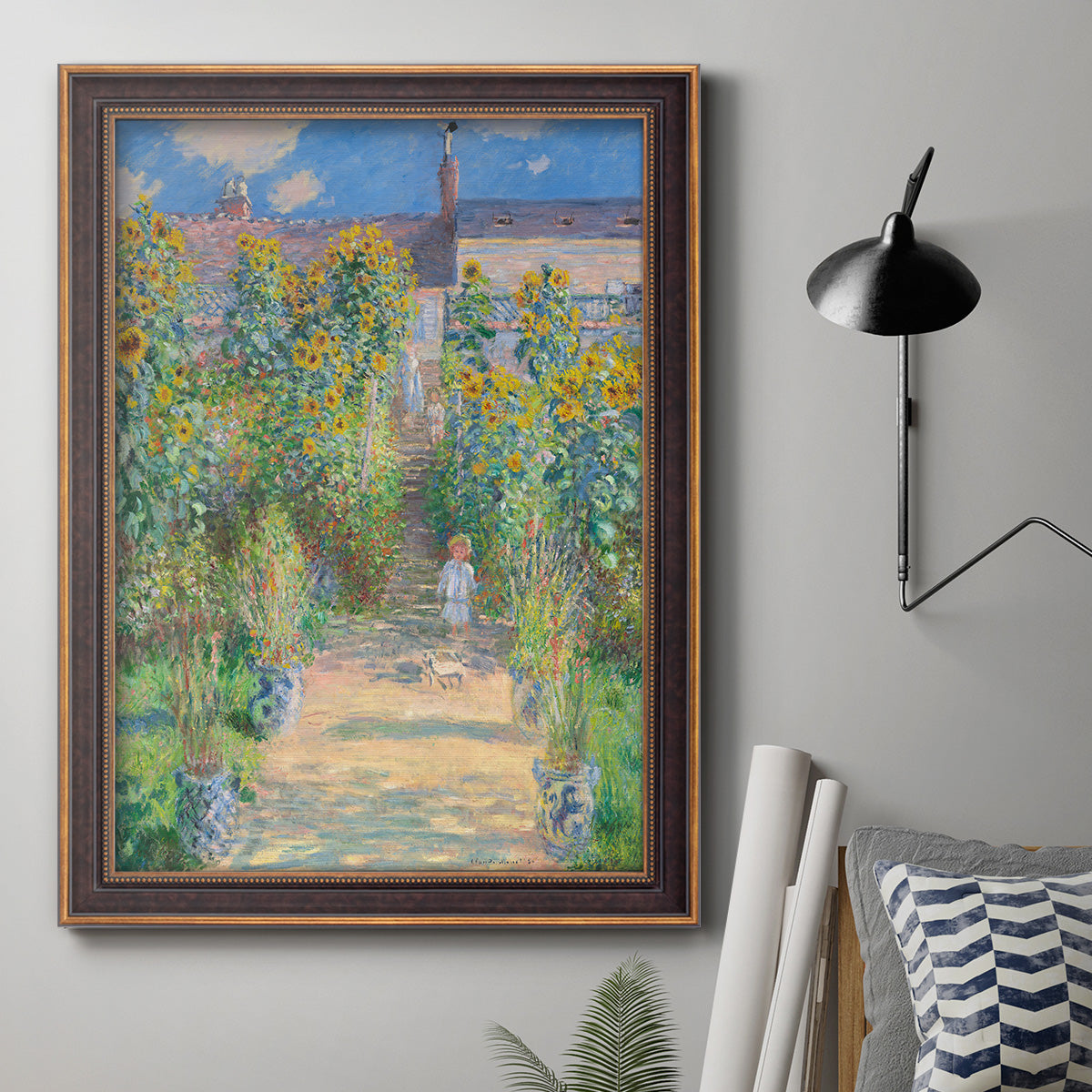 Impressionist garden landscape painting by Claude Monet in an ornate bronzed mahogany wood frame displayed in a neutral interior setting.