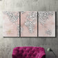 Three-panel canvas wall art featuring stylized pink cheetah world map, displayed in a living room above a suede accent chair.