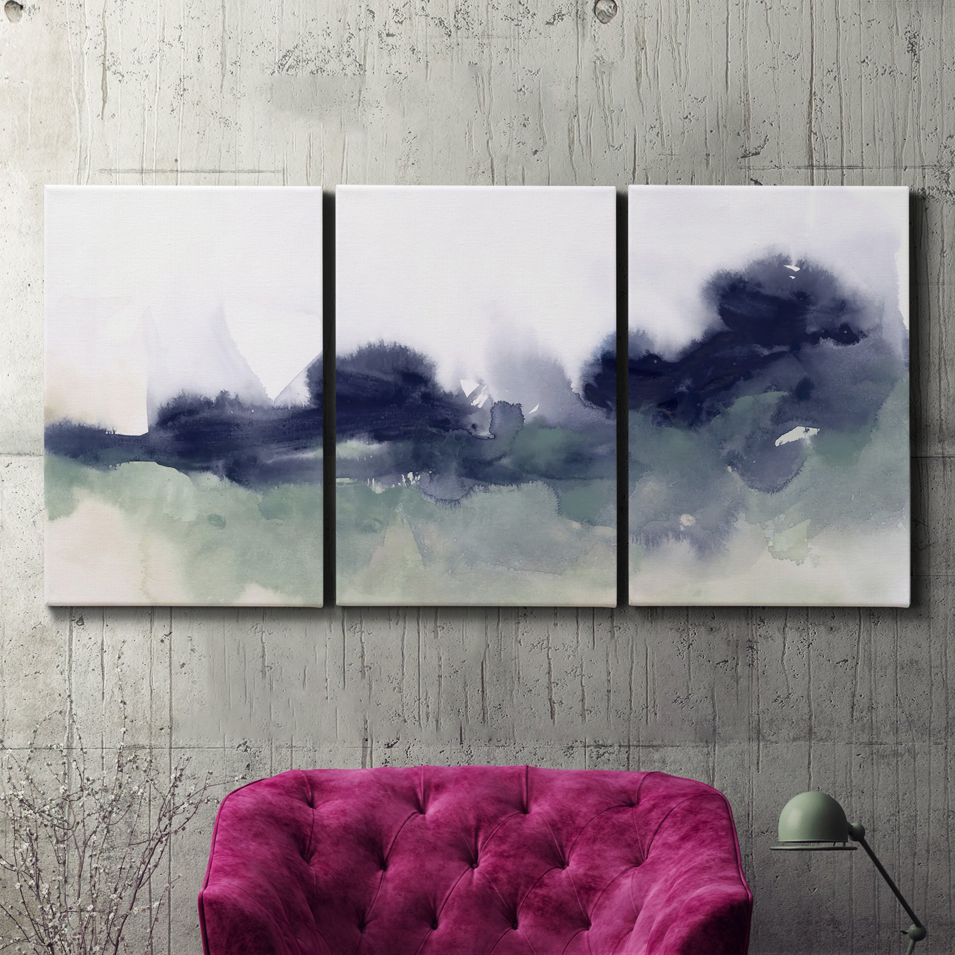 Three-panel canvas wall art featuring misty abstract lake watercolor, displayed in a living room above a suede accent chair.