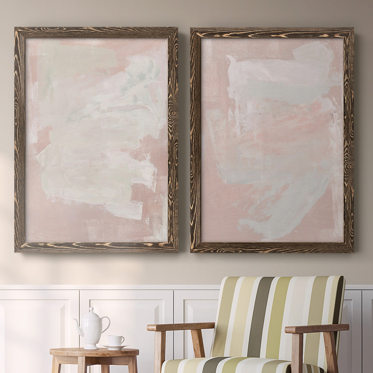 Set of two walnut barnwood framed canvas prints depicting two minimalist color-field abstracts featuring soft blush and white painterly fields above a sideboard in a cozy sitting room.
