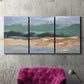 Three-panel canvas wall art featuring abstract landscape composition study, displayed in a living room above a suede accent chair.