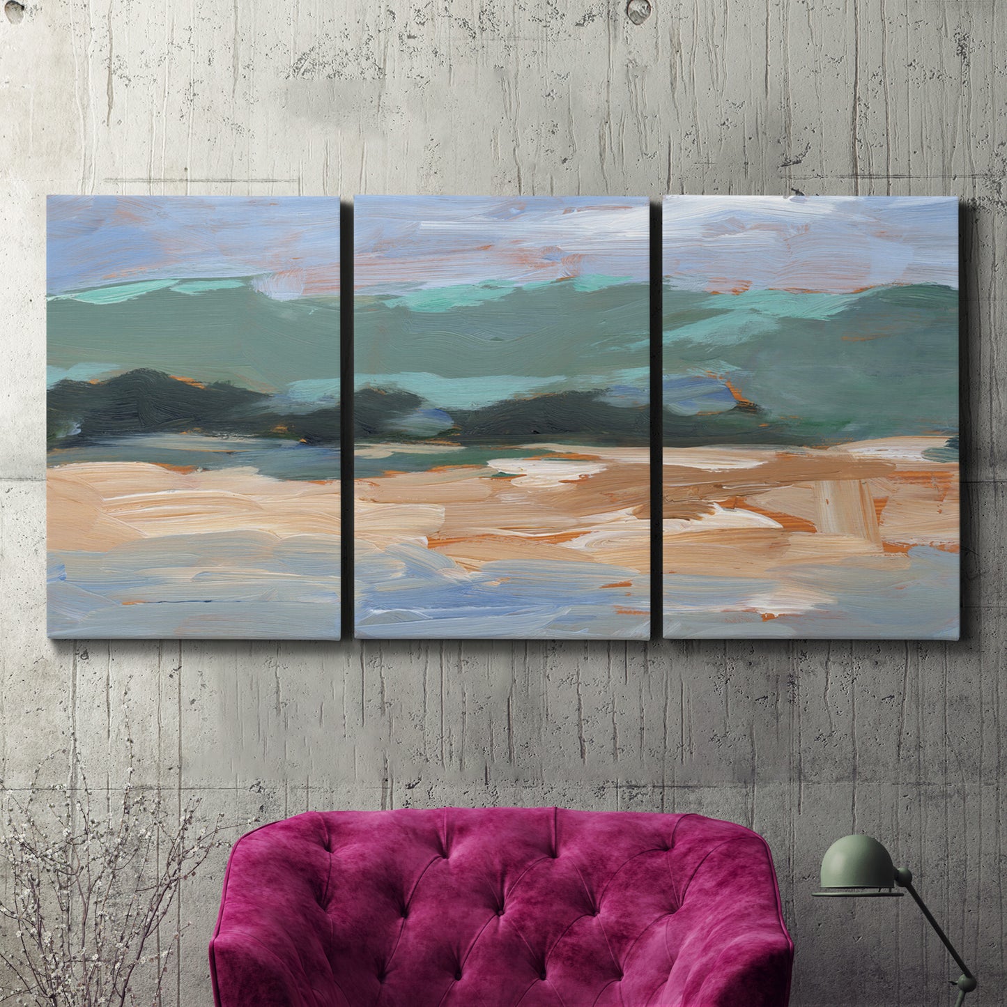 Three-panel canvas wall art featuring abstract landscape composition study, displayed in a living room above a suede accent chair.