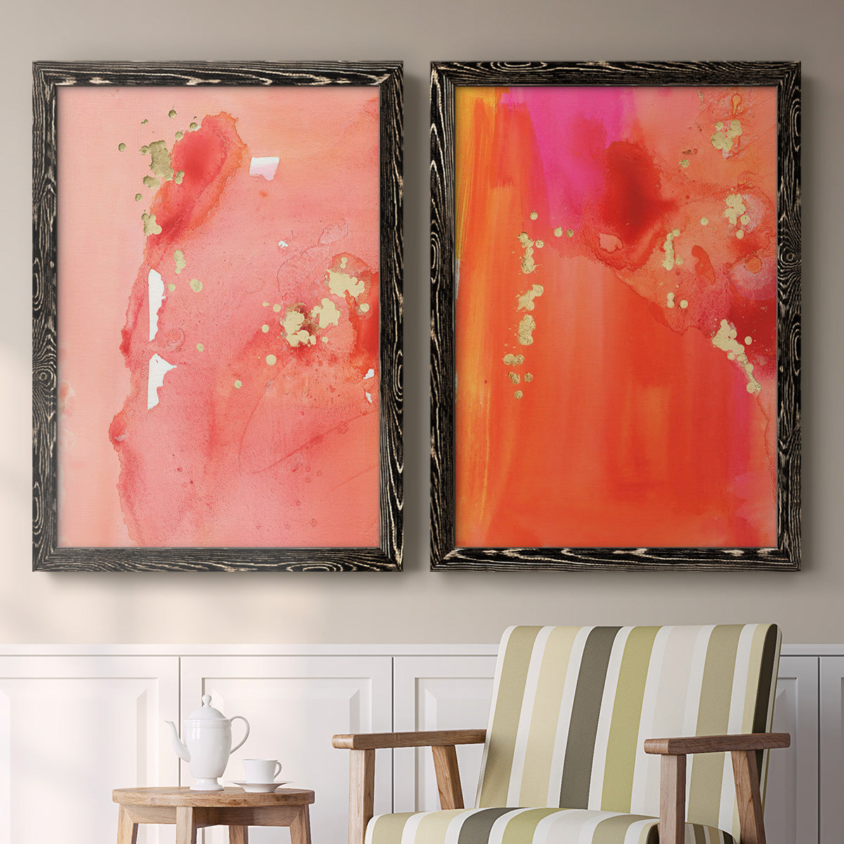 Set of two black barnwood framed canvas prints depicting two glamorous fluid abstracts featuring luminous coral orange and pink color fields with gold flecks above a sideboard in a cozy sitting room.