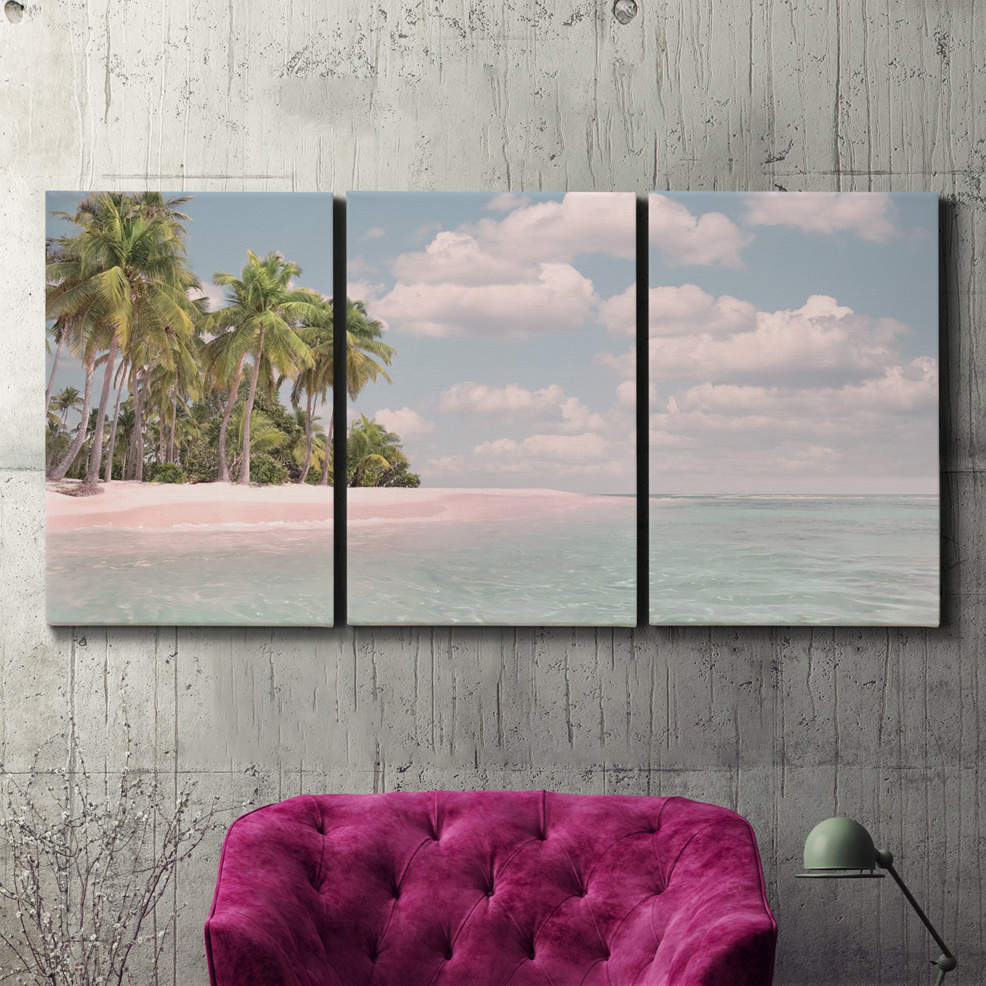 Three-panel canvas wall art featuring tropical sand dunes with palms, displayed in a living room above a suede accent chair.