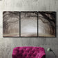 Three-panel canvas wall art featuring tree lined plantation road, displayed in a living room above a suede accent chair.