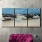 Three-panel canvas wall art featuring abstract bridge landscape in cyan, displayed in a living room above a suede accent chair.