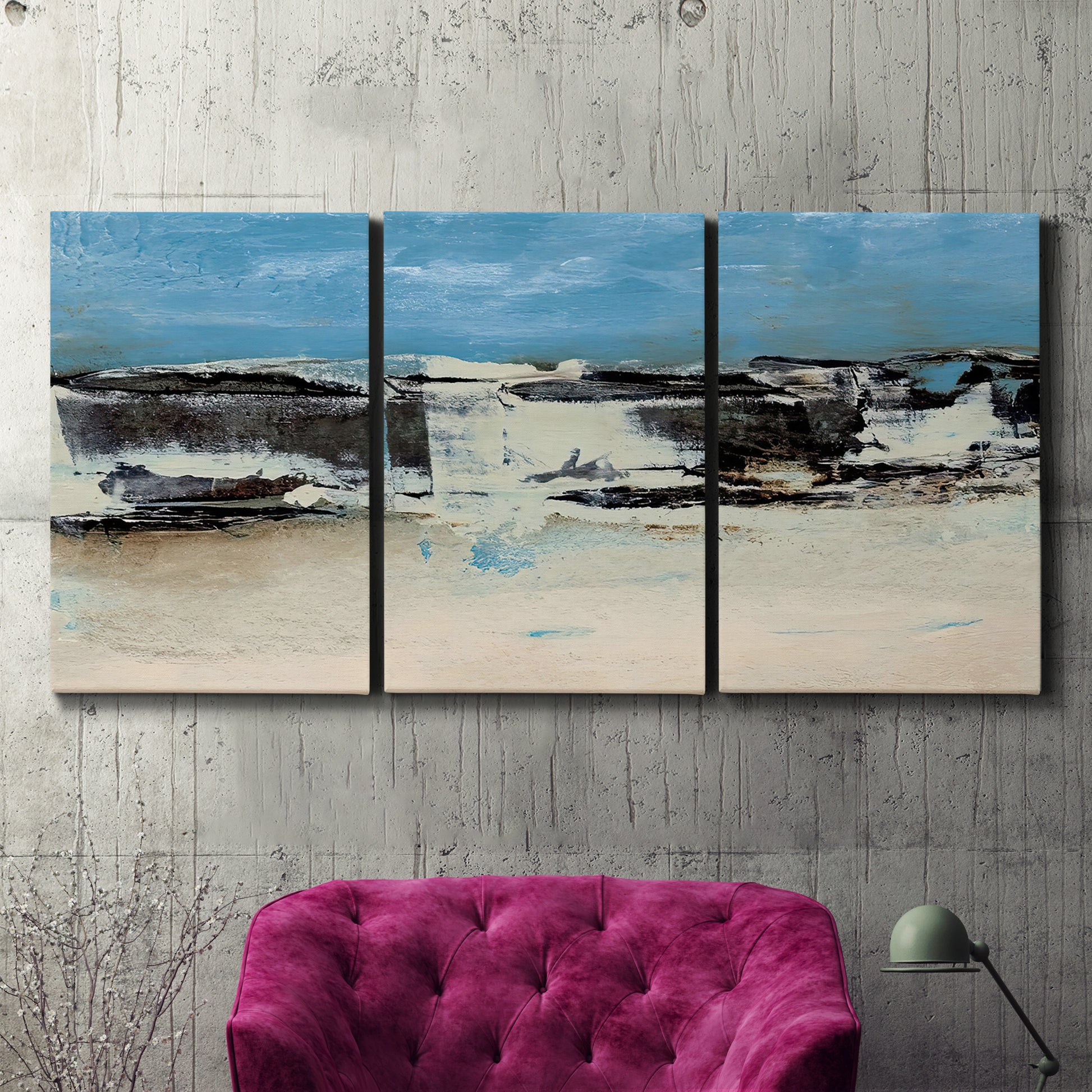 Three-panel canvas wall art featuring abstract bridge landscape in cyan, displayed in a living room above a suede accent chair.