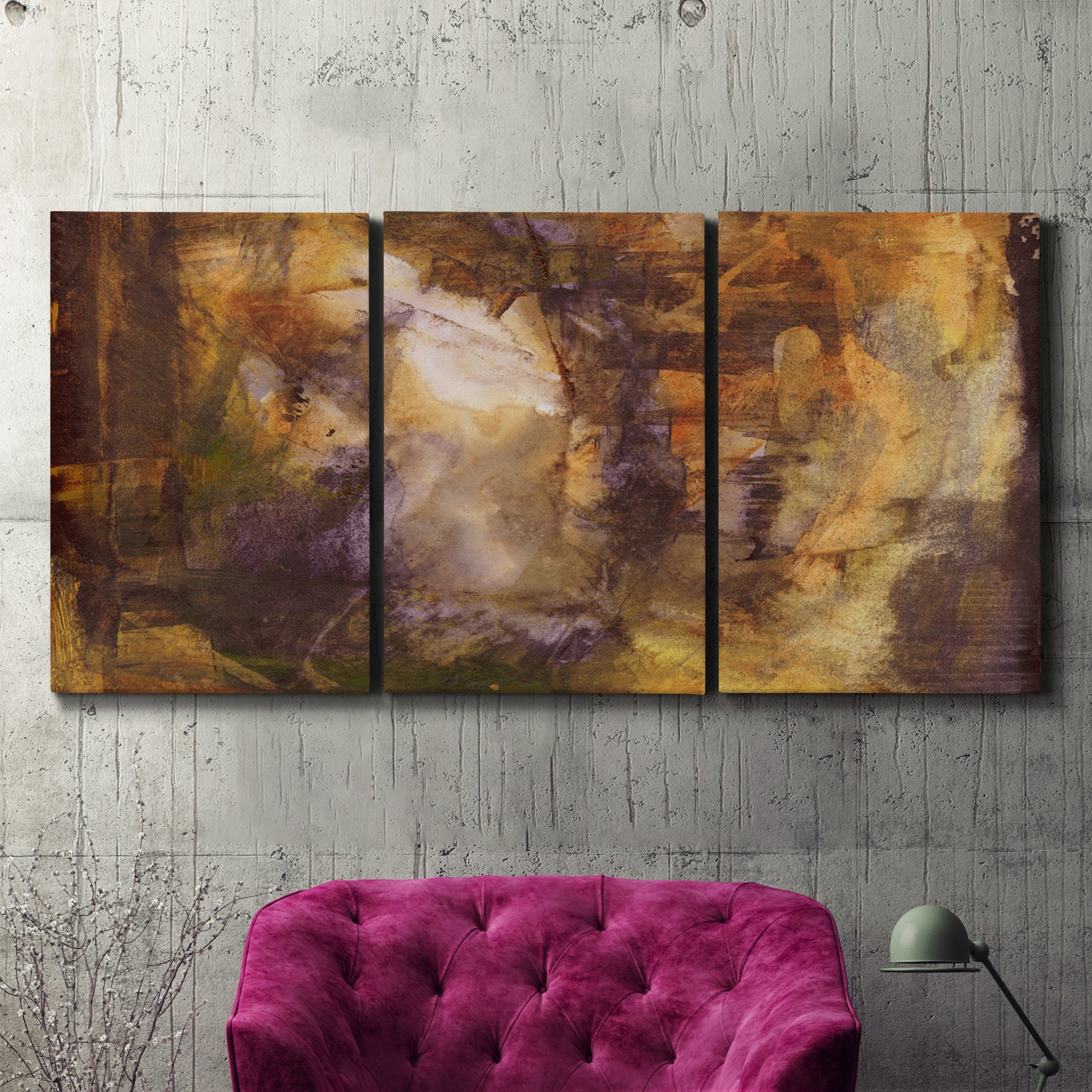 Three-panel canvas wall art featuring abstract architectural landscape, displayed in a living room above a suede accent chair.