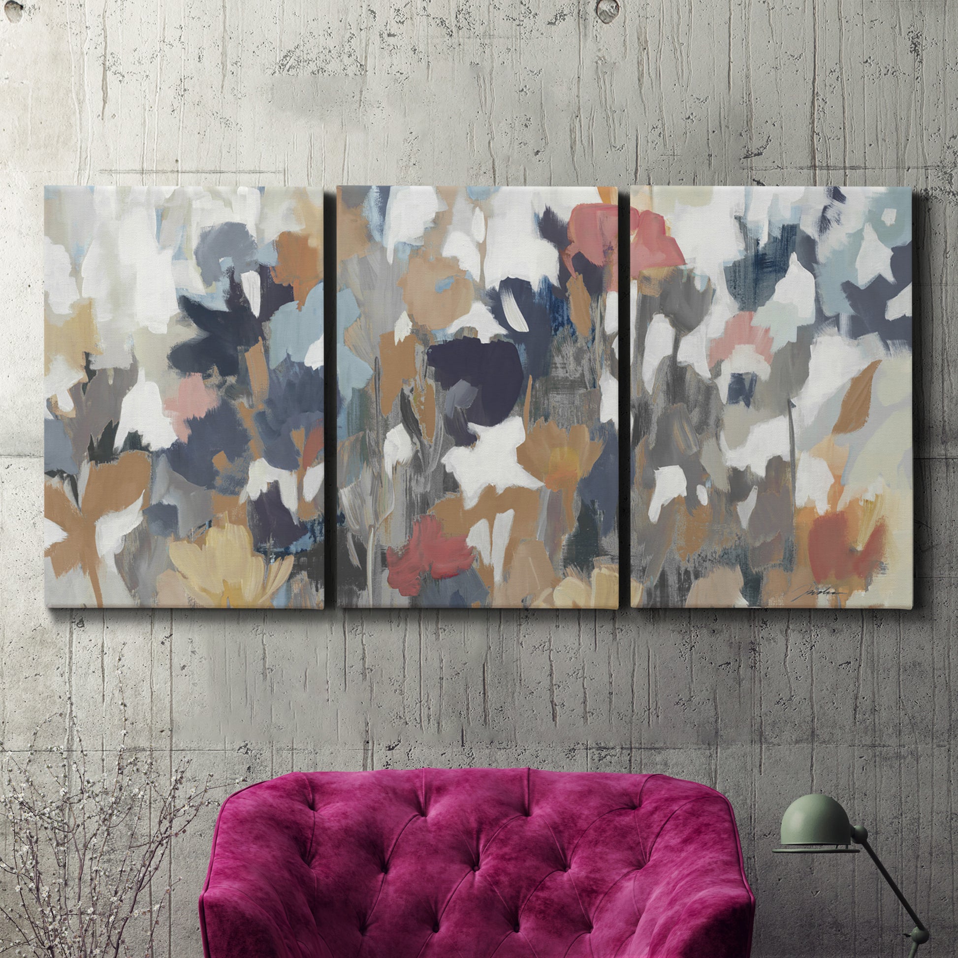 Three-panel canvas wall art featuring abstract flower stand composition, displayed in a living room above a suede accent chair.