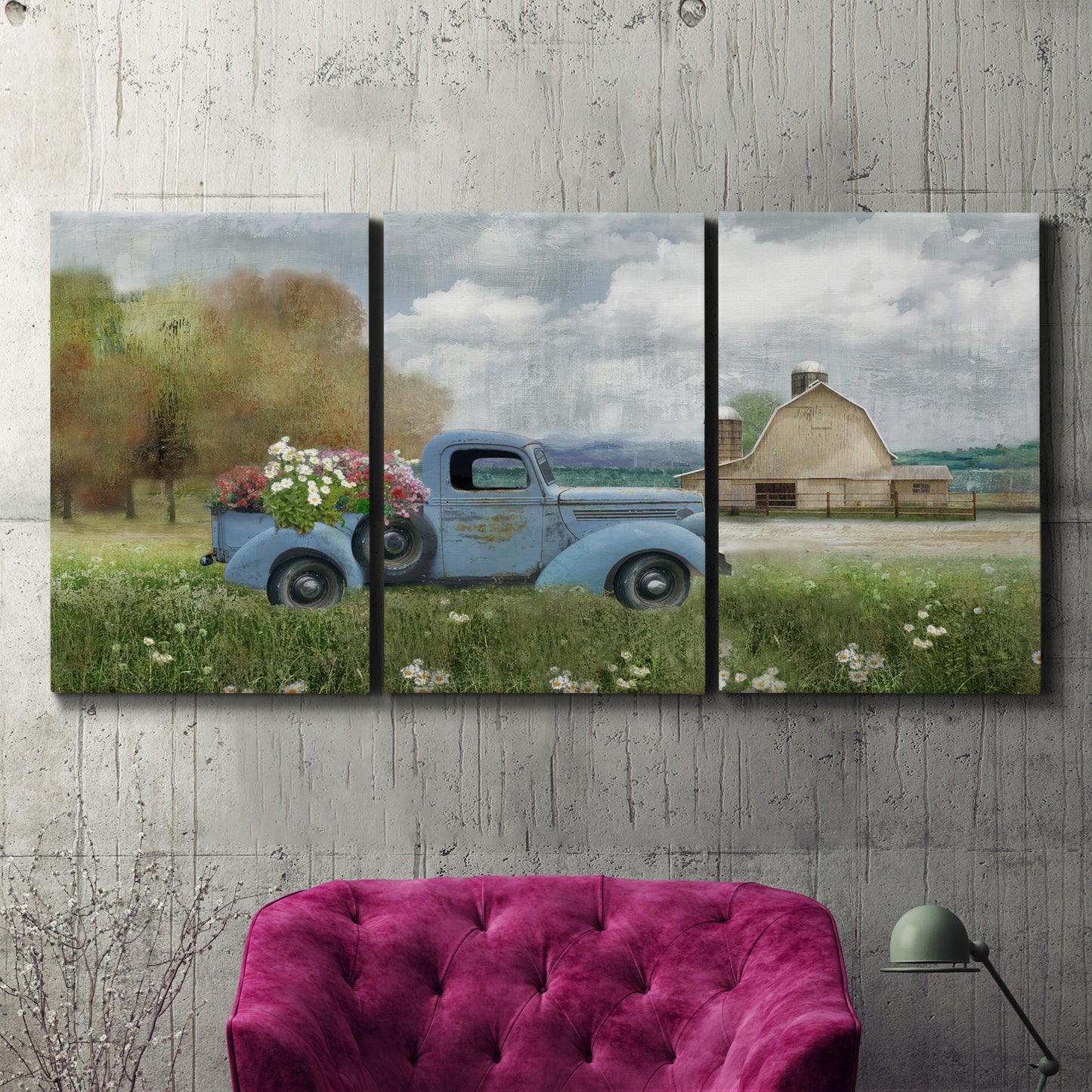 Three-panel canvas wall art featuring vintage blue truck with flower load, displayed in a living room above a suede accent chair.