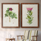 Set of two maple barnwood framed canvas prints depicting two vintage botanical plate illustrations featuring pink flowering plant specimens above a sideboard in a cozy sitting room.