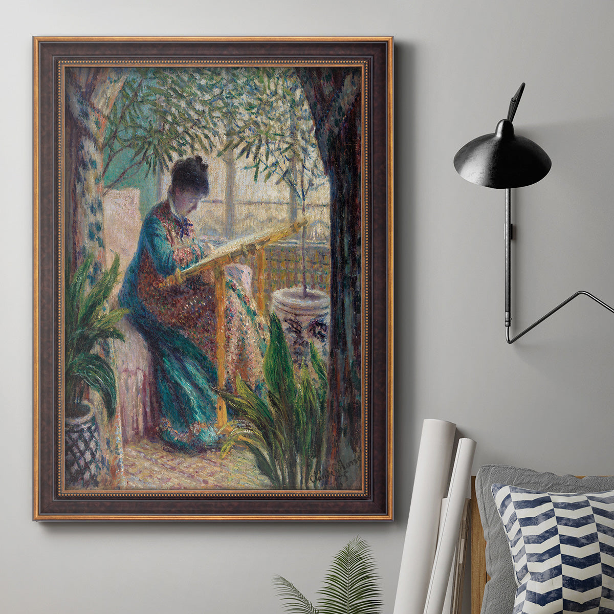 Impressionist portrait of Madame Monet sewing by Claude Monet in an ornate bronzed mahogany wood frame displayed in a neutral interior setting.