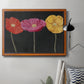 Contemporary poppy flower artwork in an ornate vintage burl wood frame displayed in a neutral interior setting.