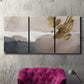 Three-panel canvas wall art featuring abstract watercolor with gold accents, displayed in a living room above a suede accent chair.