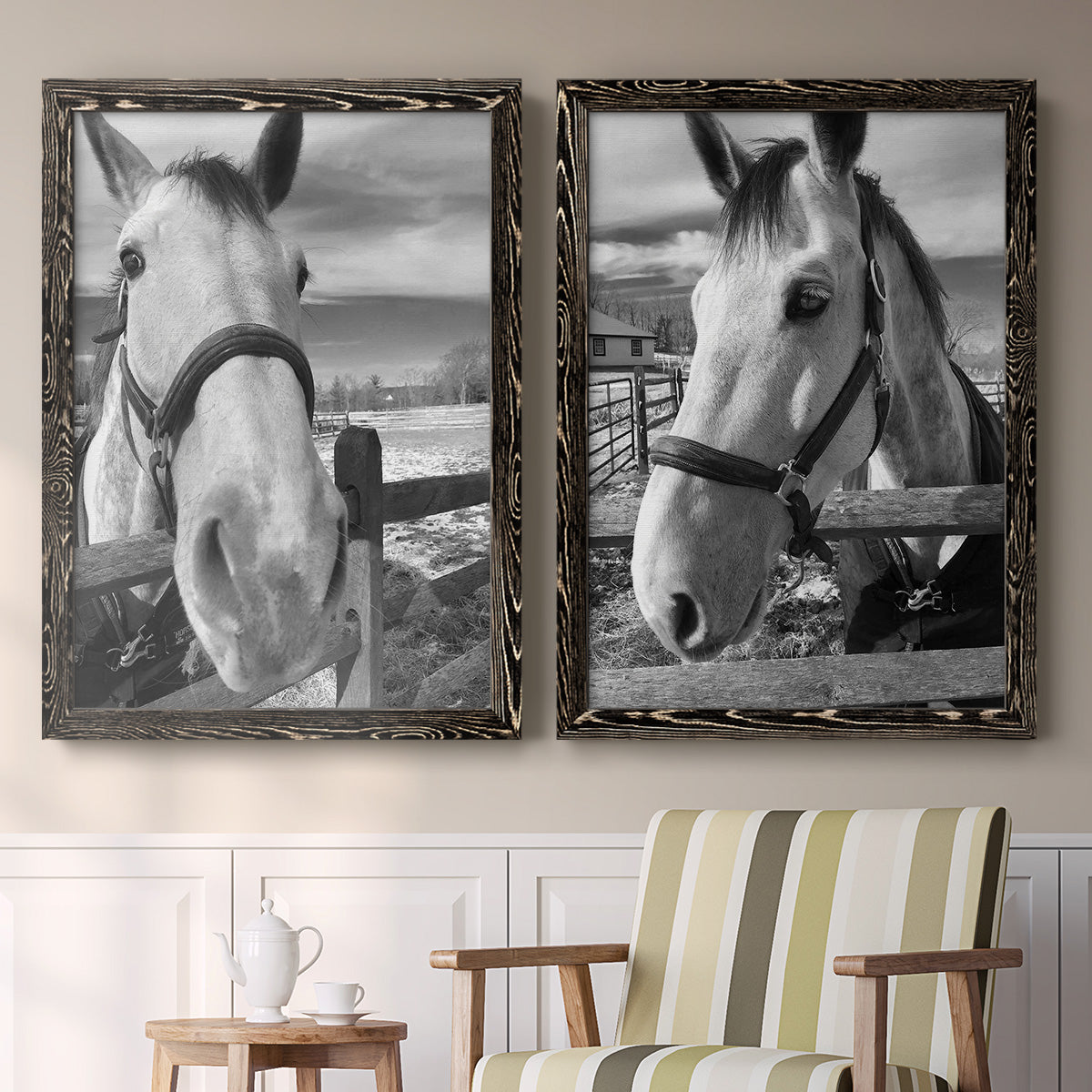 Set of two black barnwood framed canvas prints depicting two modern equestrian photography featuring black-and-white close-up portraits of horses at fences above a sideboard in a cozy sitting room.