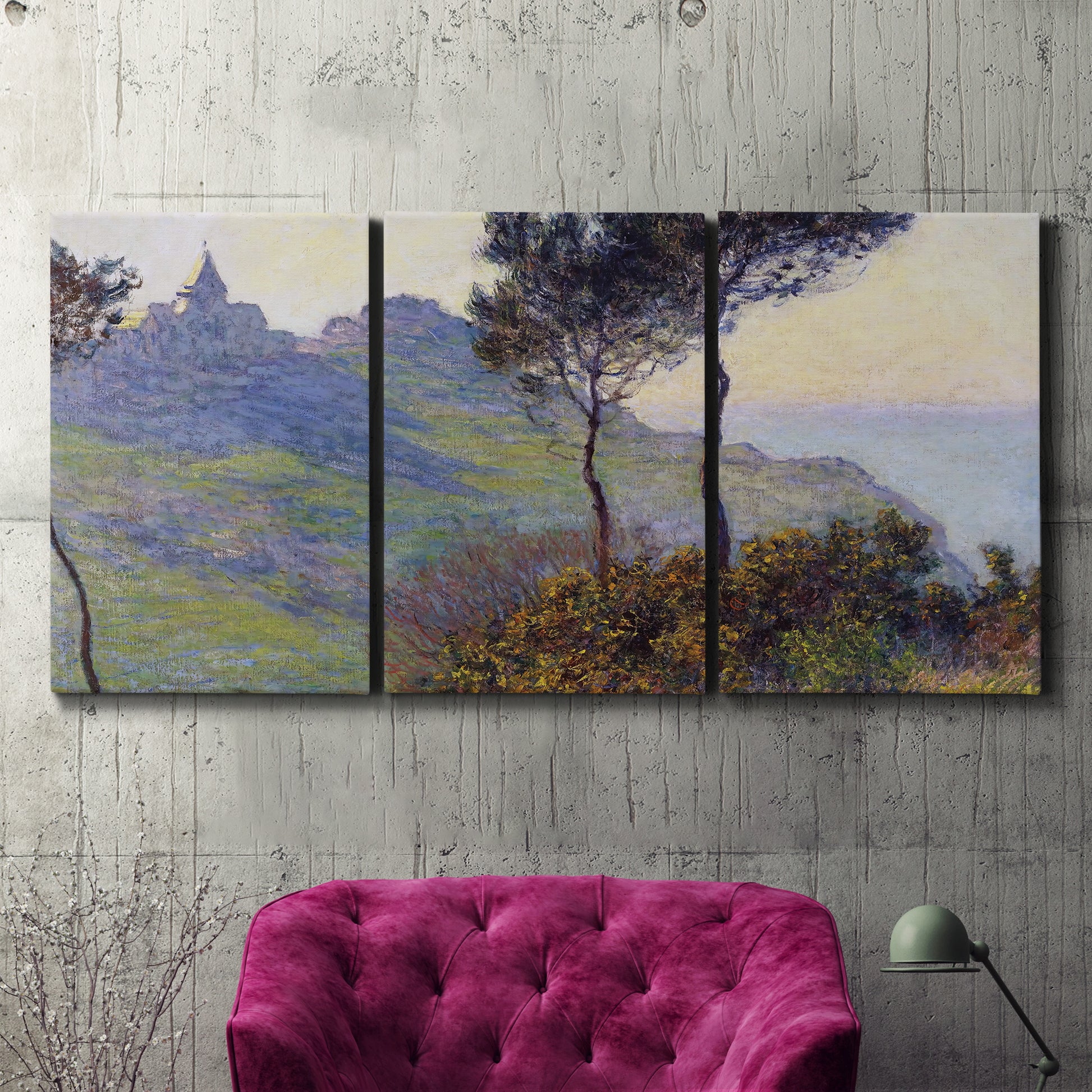 Three-panel canvas wall art featuring village church at sunset, displayed in a living room above a suede accent chair.