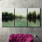 Three-panel canvas wall art featuring rain soaked landscape at sunset, displayed in a living room above a suede accent chair.