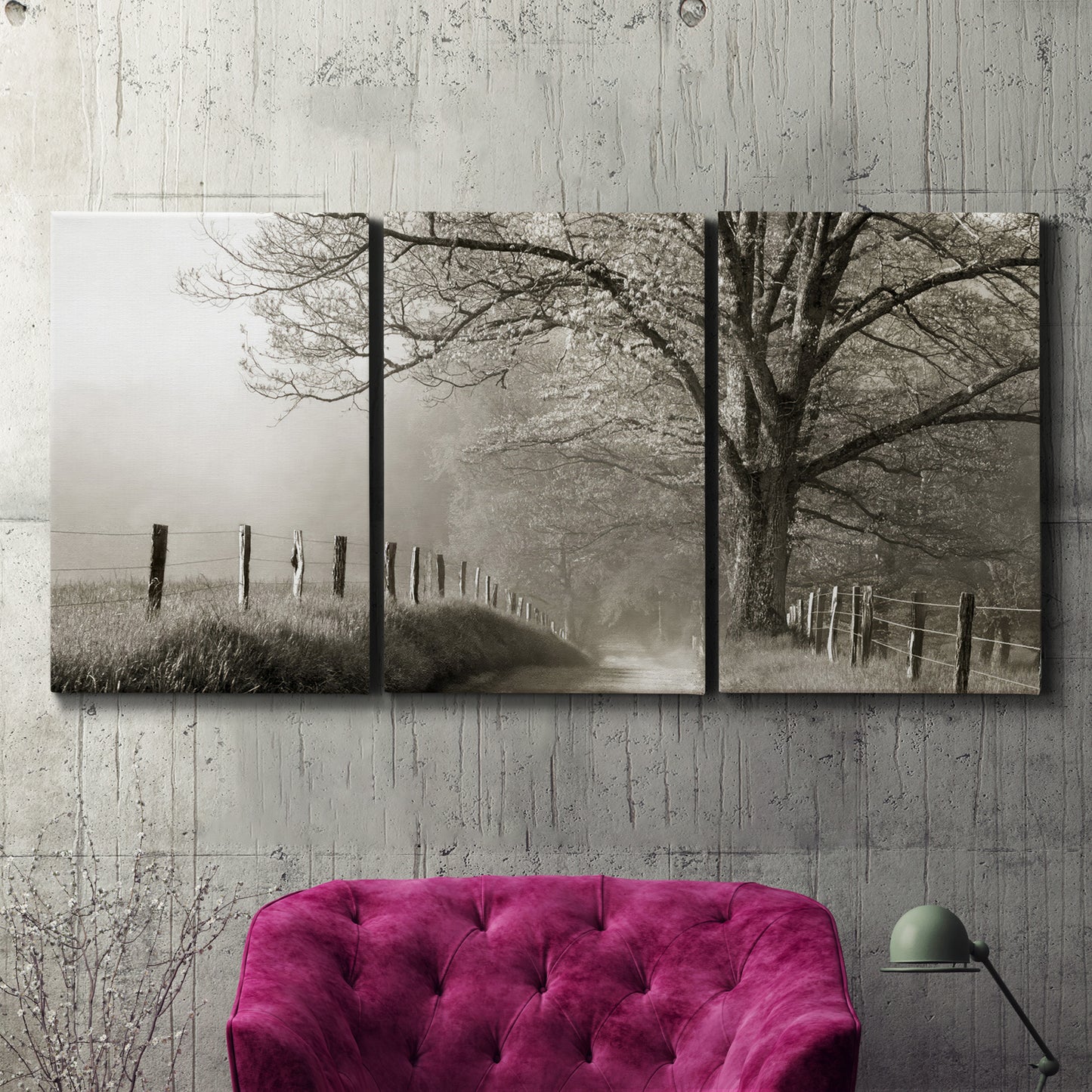 Three-panel canvas wall art featuring fenced rural path through countryside, displayed in a living room above a suede accent chair.