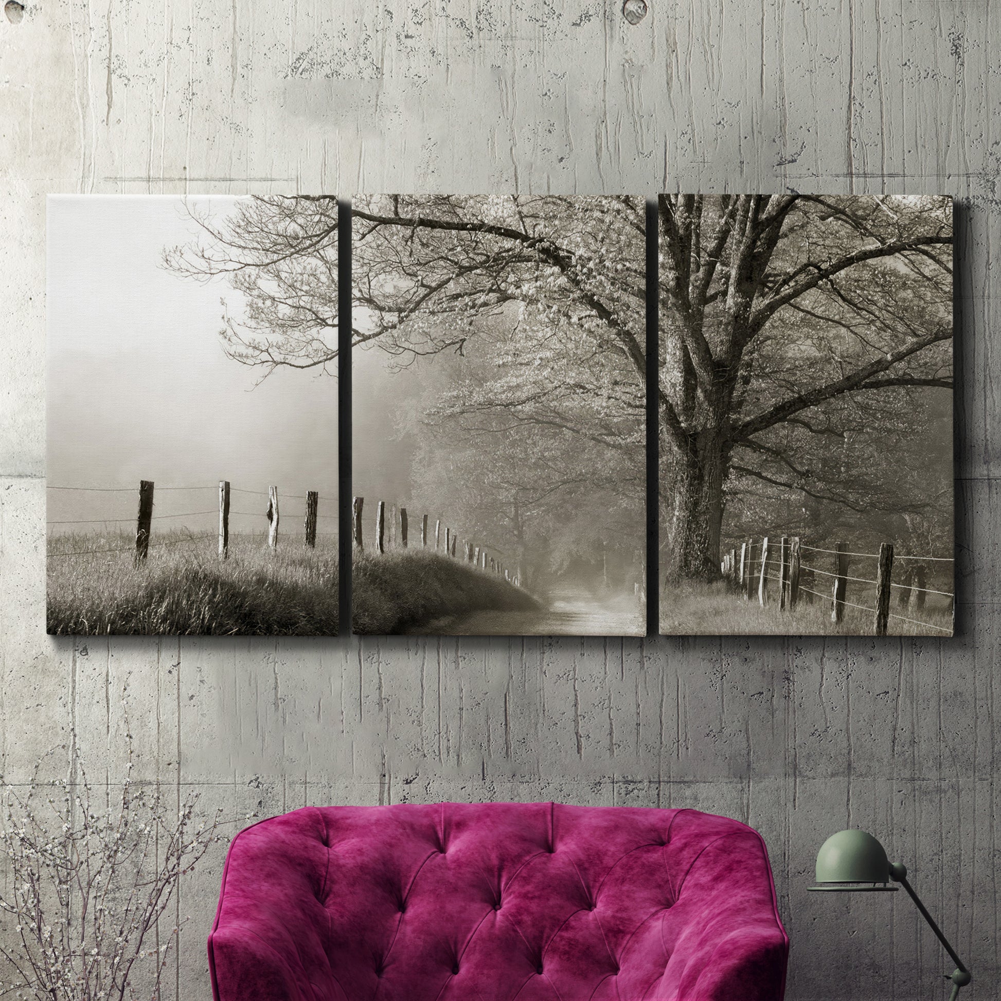 Three-panel canvas wall art featuring fenced rural path through countryside, displayed in a living room above a suede accent chair.