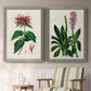 Set of two gray barnwood framed canvas prints depicting two antique botanical plate illustrations featuring colorful flowering plant specimens above a sideboard in a cozy sitting room.