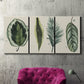 Three-panel canvas wall art featuring botanical palm leaf illustration, displayed in a living room above a suede accent chair.
