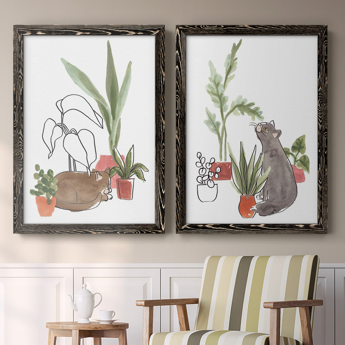 Set of two black barnwood framed canvas prints depicting two whimsical botanical animal illustrations featuring cats tucked among collections of potted houseplants above a sideboard in a cozy sitting room.
