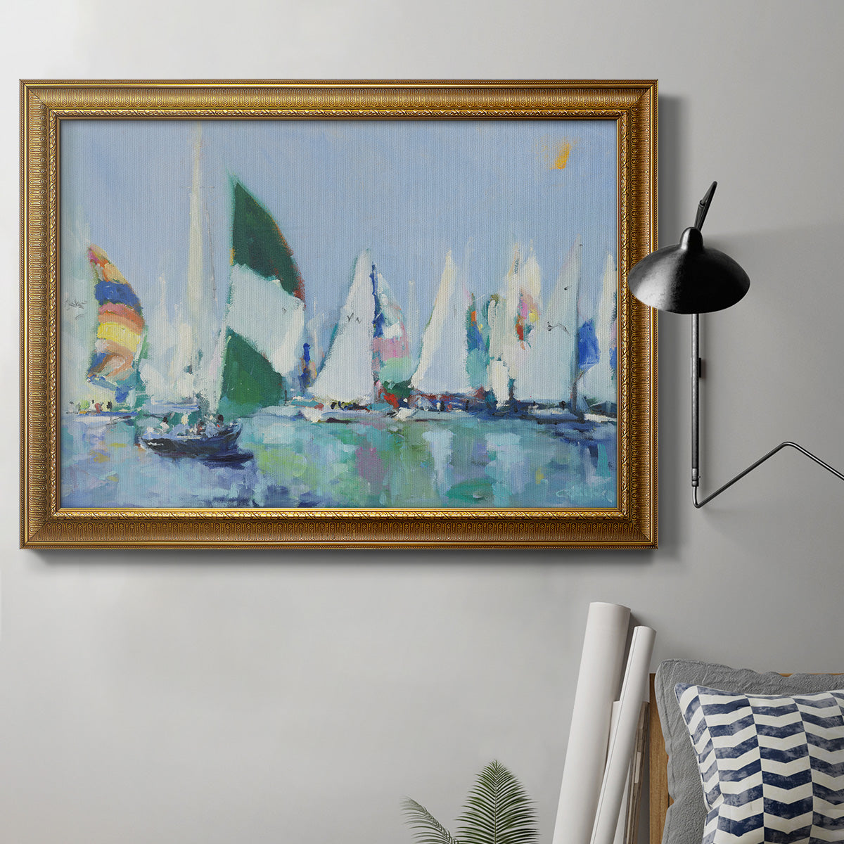 Coastal harbor watercolor painting in an ornate traditional gold frame displayed in a neutral interior setting.