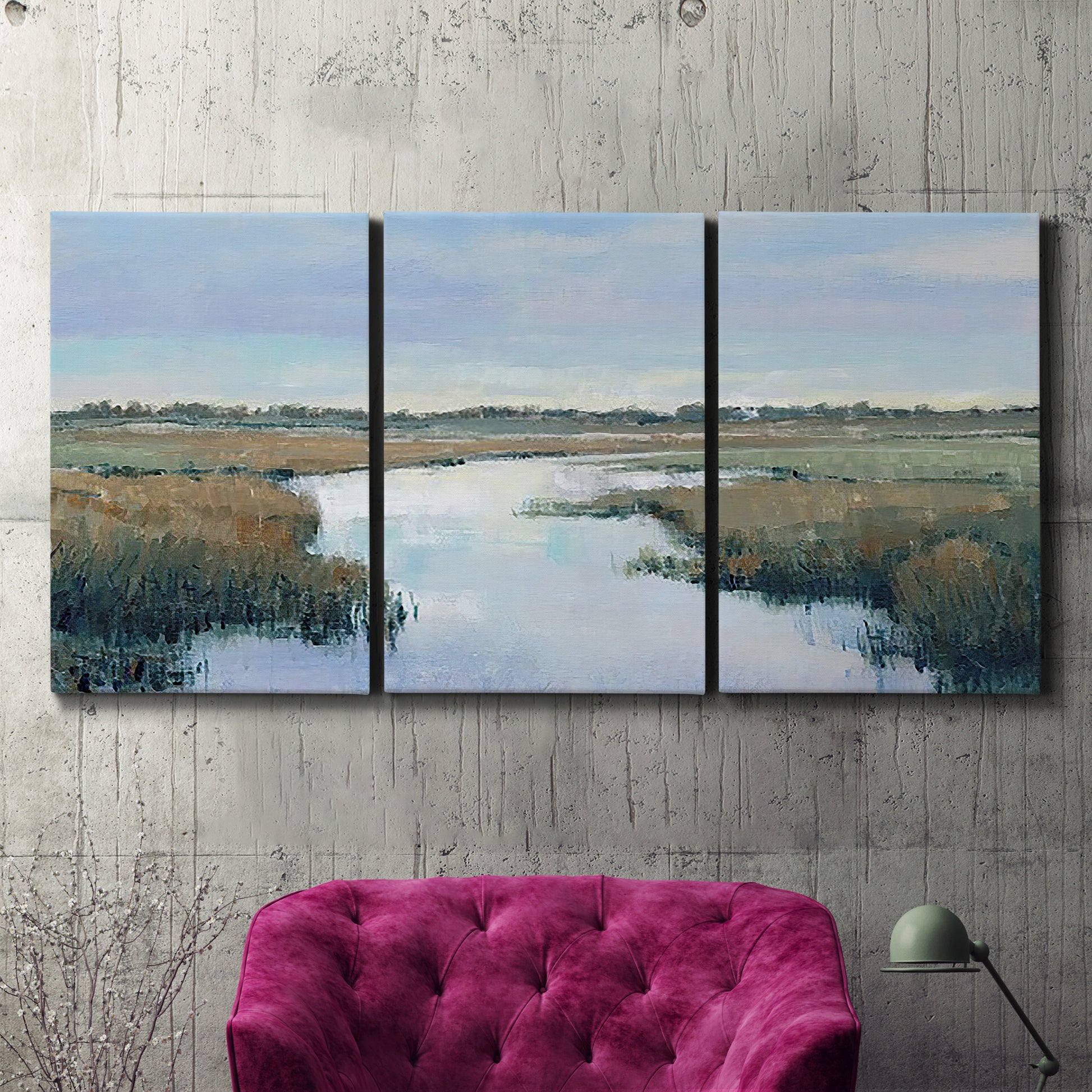 Three-panel canvas wall art featuring coastal plain with layered horizon, displayed in a living room above a suede accent chair.