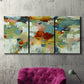 Three-panel canvas wall art featuring celebratory abstract color movement, displayed in a living room above a suede accent chair.