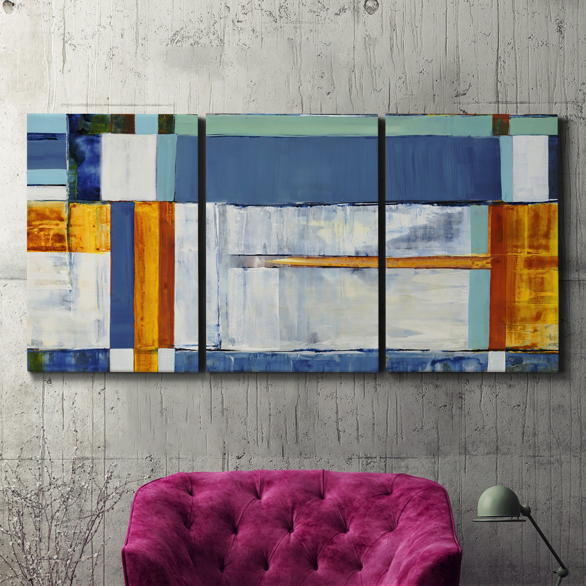 Three-panel canvas wall art featuring bright mid century geometric abstraction, displayed in a living room above a suede accent chair.