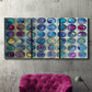 Three-panel canvas wall art featuring contrasting geometric abstract variations, displayed in a living room above a suede accent chair.