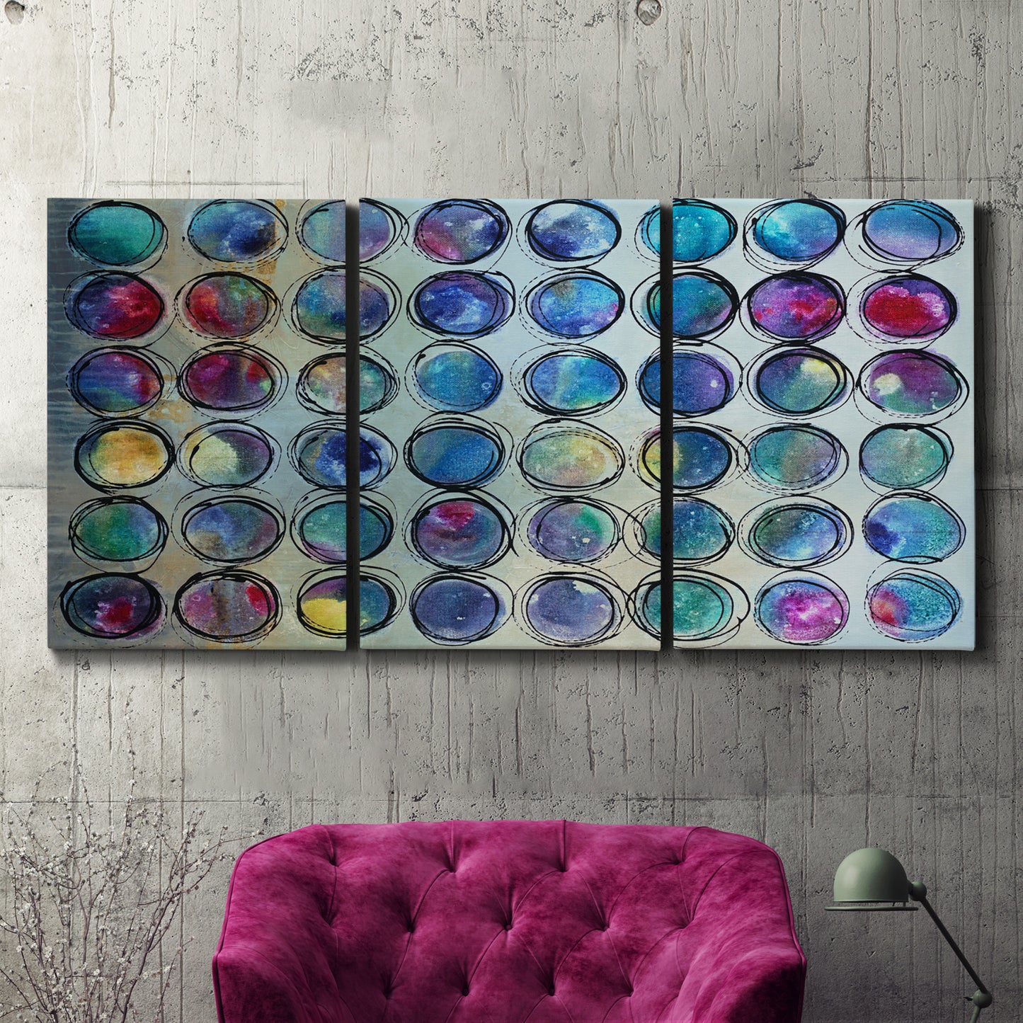 Three-panel canvas wall art featuring contrasting geometric abstract variations, displayed in a living room above a suede accent chair.