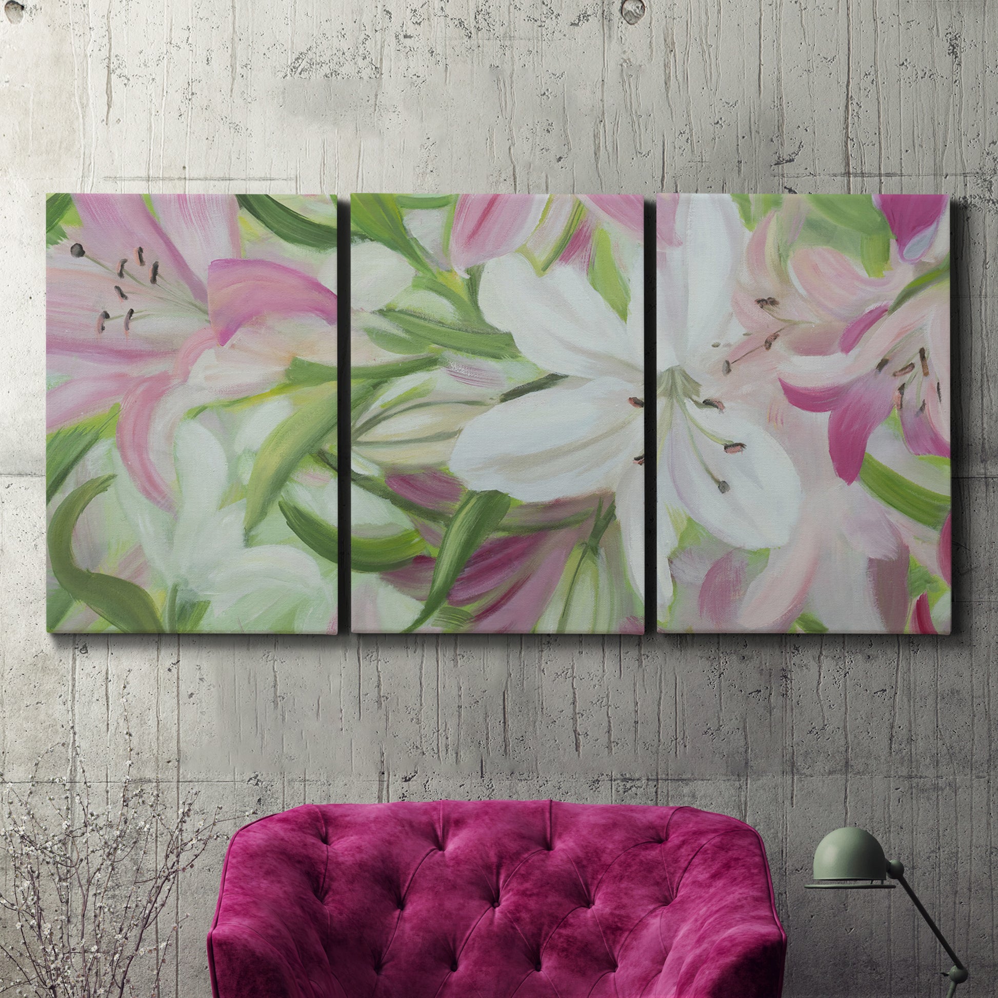 Three-panel canvas wall art featuring pink and white lilies botanical study, displayed in a living room above a suede accent chair.