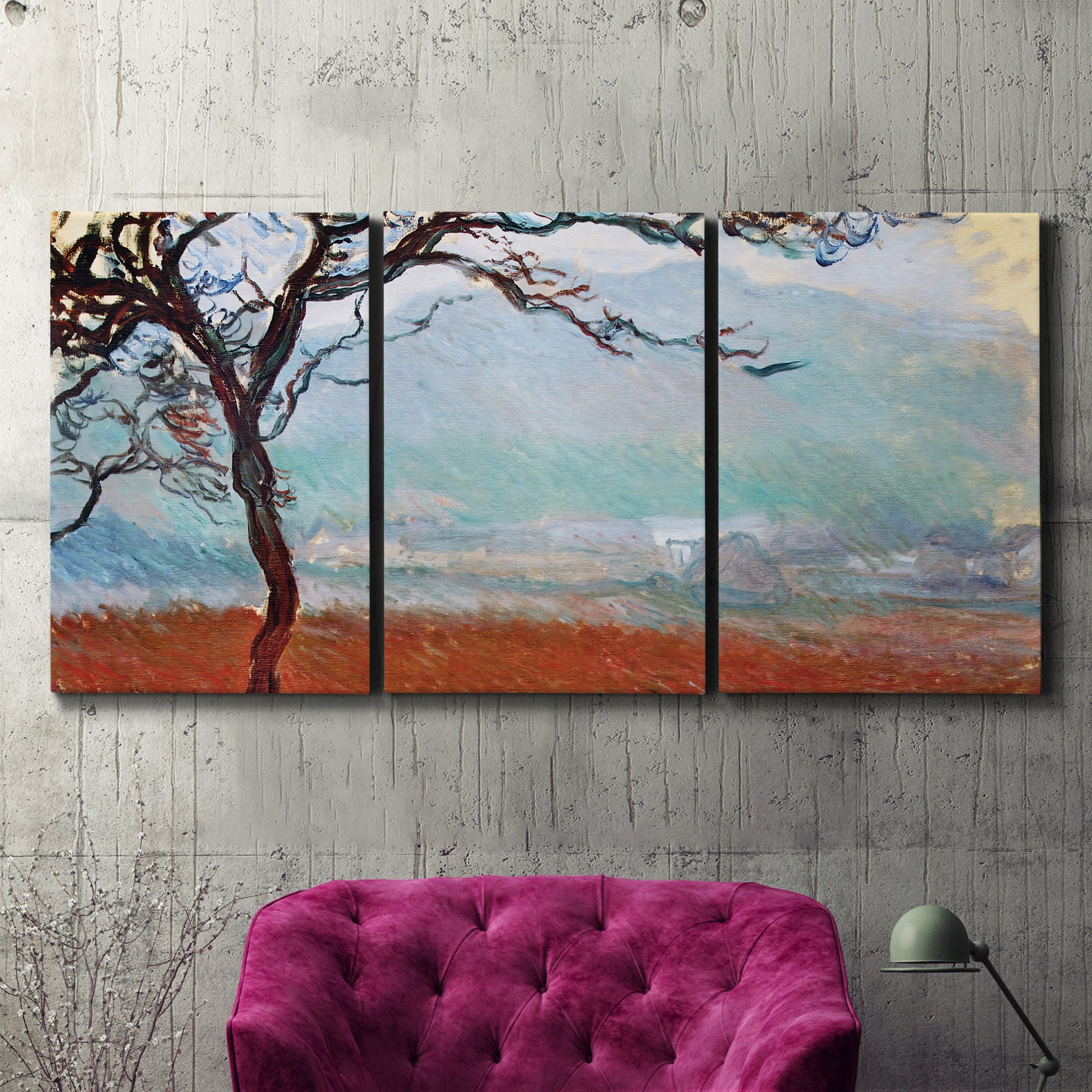 Three-panel canvas wall art featuring coastal trees at evening light, displayed in a living room above a suede accent chair.