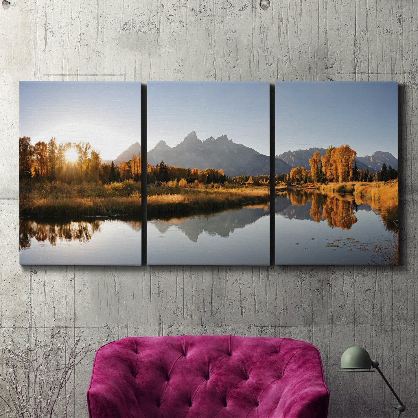 Three-panel canvas wall art featuring river canyon landscape photograph, displayed in a living room above a suede accent chair.