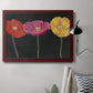 Contemporary poppy flower artwork in an ornate cherry burl wood frame displayed in a neutral interior setting.