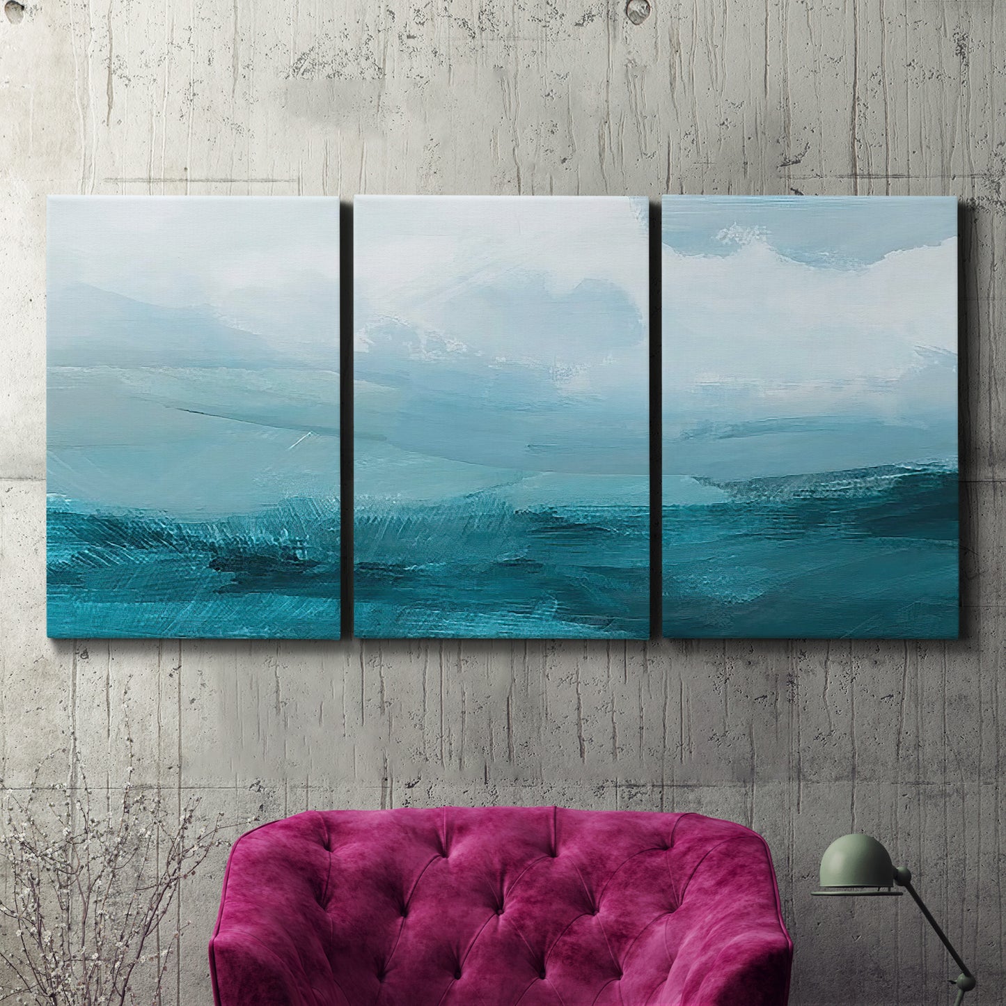 Three-panel canvas wall art featuring vertical coastal elements with rising light, displayed in a living room above a suede accent chair.