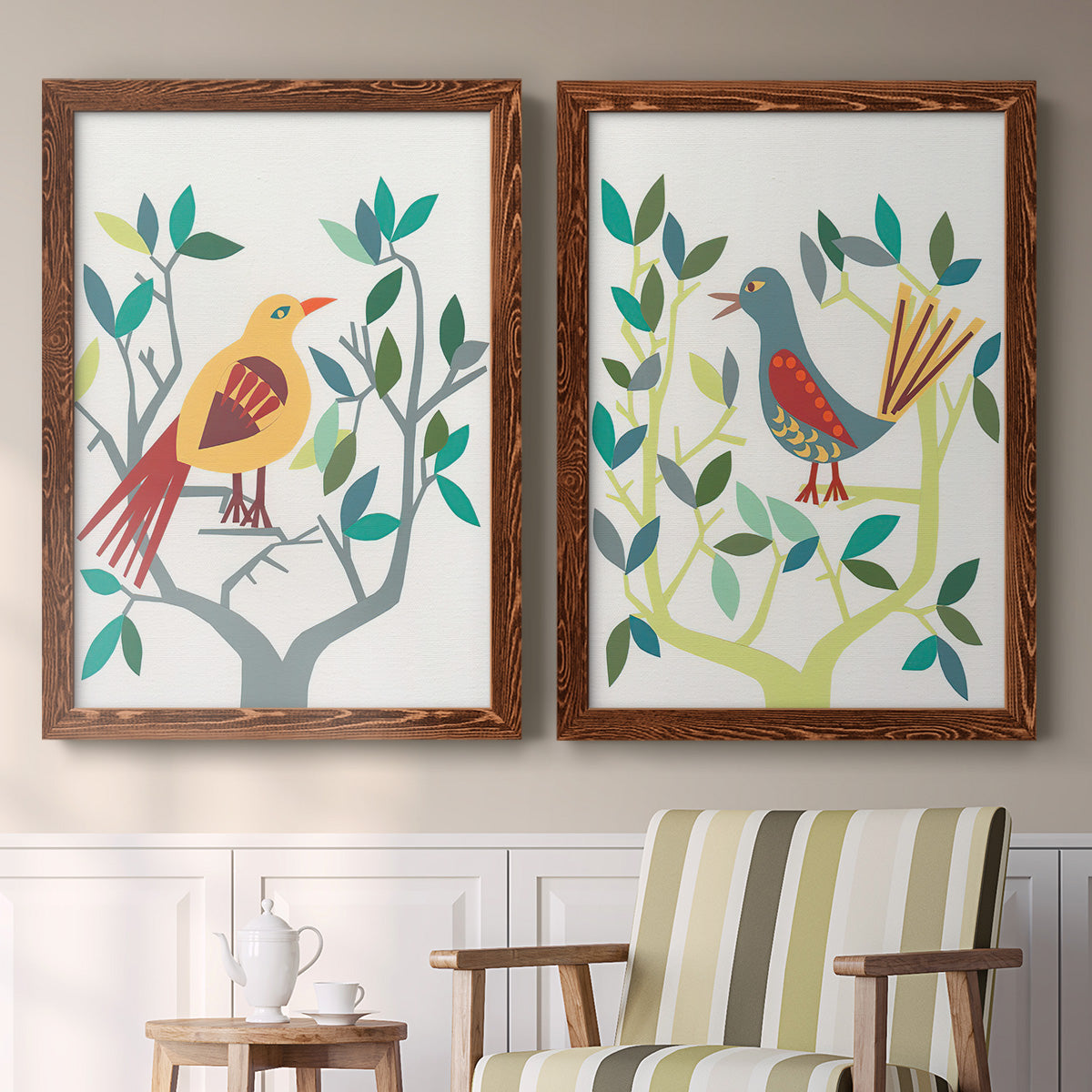 Set of two maple barnwood framed canvas prints depicting two modern folk-art bird illustrations featuring stylized colorful birds perched among leafy branches above a sideboard in a cozy sitting room.