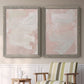 Set of two gray barnwood framed canvas prints depicting two minimalist color-field abstracts featuring soft blush and white painterly fields above a sideboard in a cozy sitting room.