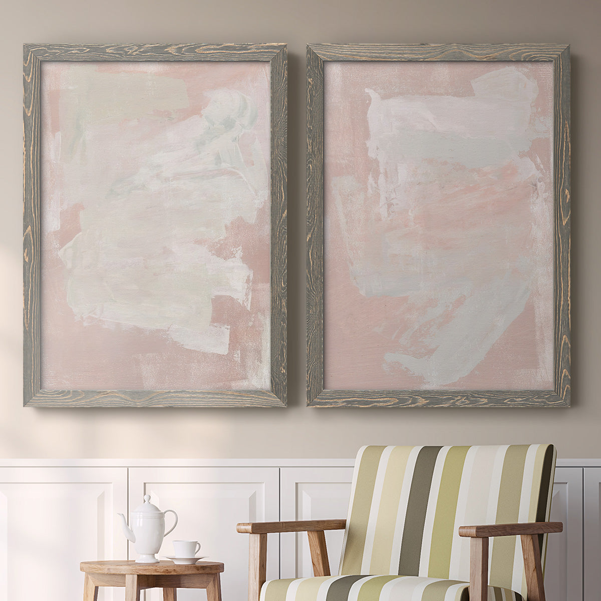 Set of two gray barnwood framed canvas prints depicting two minimalist color-field abstracts featuring soft blush and white painterly fields above a sideboard in a cozy sitting room.