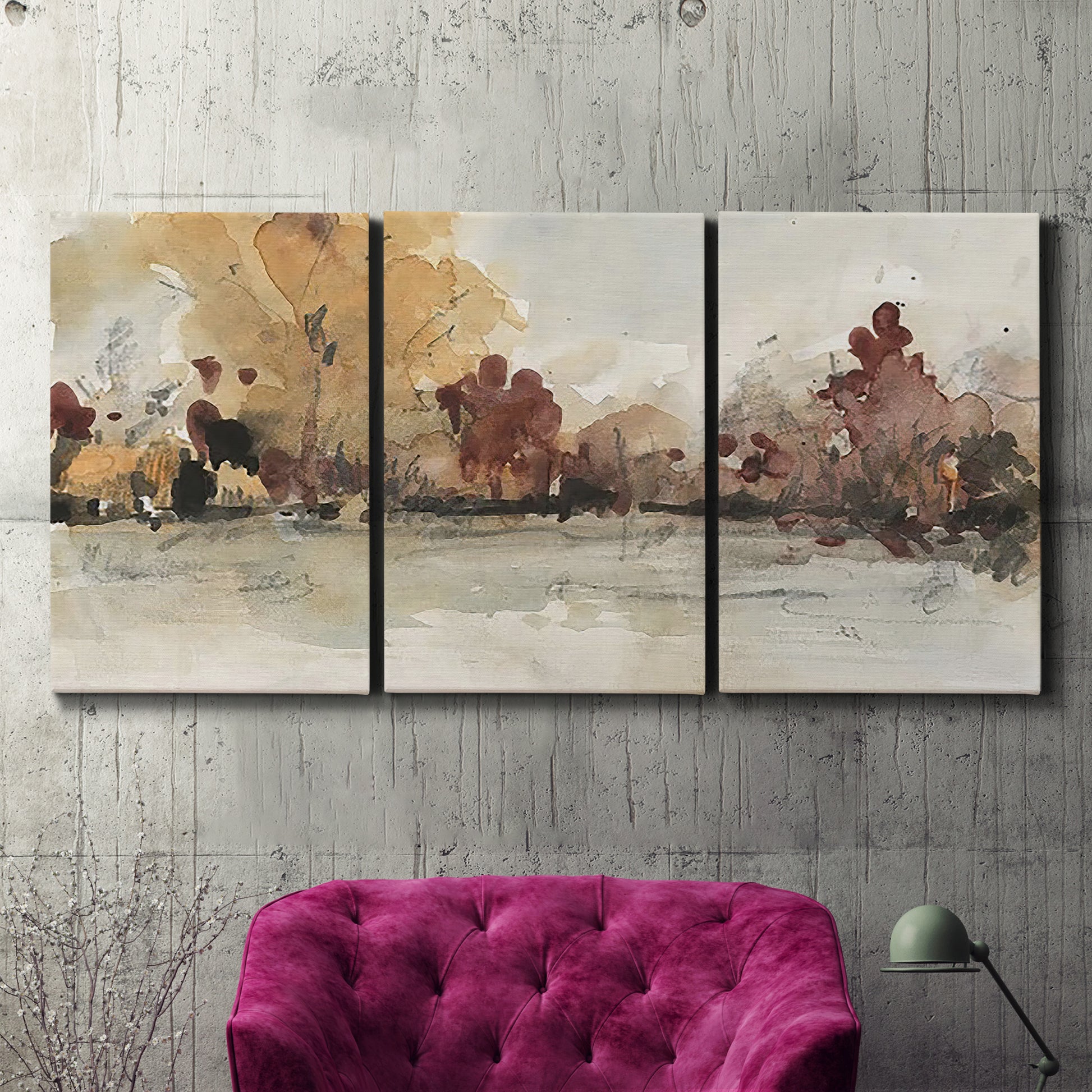 Three-panel canvas wall art featuring autumn landscape with trees and field, displayed in a living room above a suede accent chair.