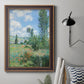 Impressionist pastoral landscape with poppy fields by Claude Monet in an ornate bronzed mahogany wood frame displayed in a neutral interior setting.