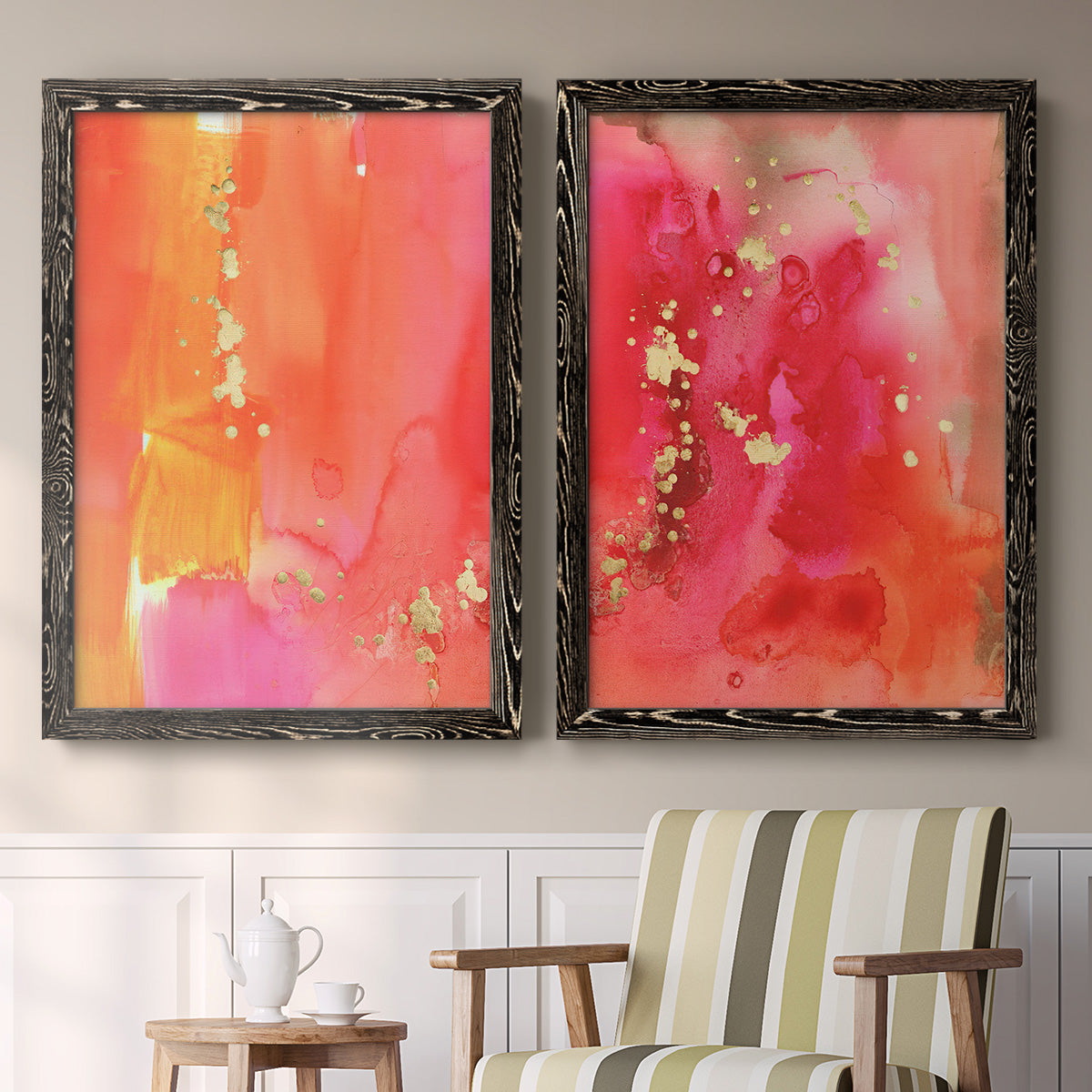 Set of two black barnwood framed canvas prints depicting two glamorous fluid abstracts featuring luminous coral orange and pink color fields with gold flecks above a sideboard in a cozy sitting room.