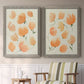Set of two gray barnwood framed canvas prints depicting two airy watercolor floral paintings featuring loose peach-orange tulip-like blossoms above a sideboard in a cozy sitting room.